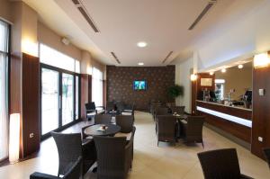 a restaurant with tables and chairs and a bar at Hotel Fontana in Buzet