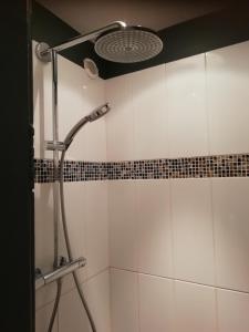 a shower in a bathroom with white tiles at Le Cottage in Nantes +31 photos