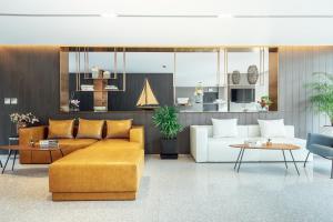 a living room with a couch and a table at Montana Bangkok Hotel & Residence in Bangkok