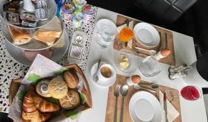 a table with bread and plates and utensils on it at B&B Haus Kristal in Walsdorf