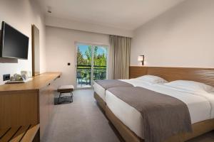 Postel nebo postele na pokoji v ubytování Platanista Hotel