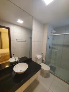 ein Badezimmer mit Waschbecken, Toilette und Dusche in der Unterkunft Iloa 3 quartos Luxo in Barra de São Miguel