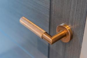 a brass door handle on a wooden door at Oddfellows Hall in Thetford