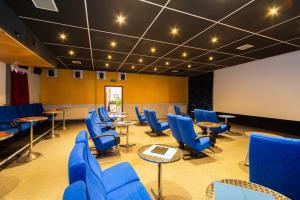 a conference room with blue chairs and tables at Pension Zum Schotten in Zella-Mehlis
