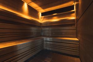 a sauna with wooden walls and a wooden ceiling at The Tytherington in Macclesfield