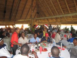 a group of people sitting at tables in a restaurant at Lituba Lodge 