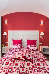 a red bedroom with a large bed with red walls at Apartments Amalfi Design in Amalfi