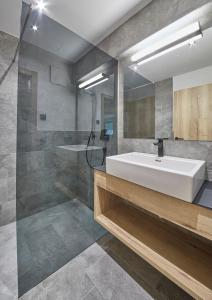 a bathroom with a white sink and a shower at Appartements Gappmaier in Saalbach Hinterglemm +160 photos