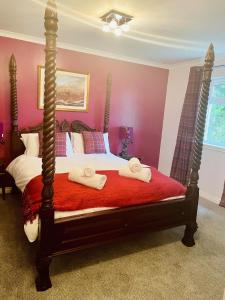 a bedroom with a bed with two towels on it at Remus B&B in Lochgelly