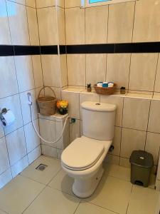 a bathroom with a white toilet in a room at Nyali Emirates Reef Apartment in Mombasa +25 photos
