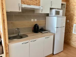 a kitchen with a sink and a white refrigerator at Vistas al mar 2 Canabal in A Coruña +5 photos
