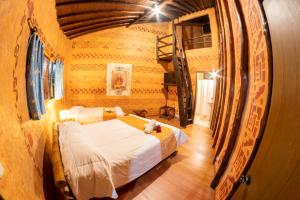 a bedroom with a large bed in a room with a wooden floor at San Agustin Internacional Hotel in San Agustín +127 photos