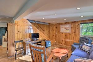 a living room with wood paneling and a staircase at Aunt Als Place with Private Deck and Fire Pit! in Rushville