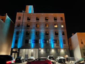 a building with blue lights on the side of it at King Hotel Brooklyn Sunset Park in Brooklyn