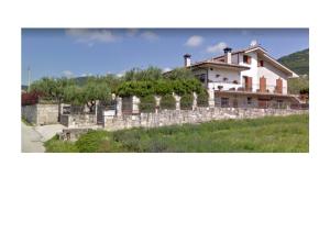 une maison sur une colline avec une clôture en pierre dans l'établissement B&B Villa Maria Paola - Alloggi Temporanei Isernia, à Isernia