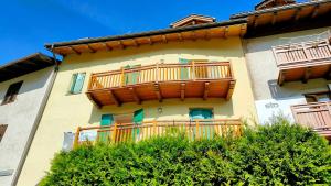 a building with wooden balconies on the side of it at CASA EMMA in Mezzana