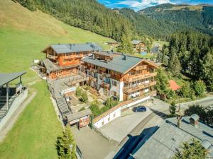 an aerial view of a large house in the mountains at Dreany apartment right next to the cable cars in Hollersbach im Pinzgau