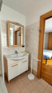 W łazience znajduje się umywalka i lustro. w obiekcie CASA EMMA w mieście Mezzana