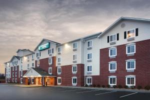 a large building with a sign on the side of it at WoodSpring Suites Virginia Beach in Virginia Beach