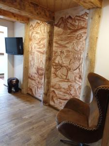 a living room with a wall with a painting on it at Izba w centrum miasta in Zakopane