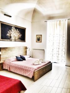 ein Schlafzimmer mit einem Bett und einem großen Fenster in der Unterkunft Palazzo Salìa in Lecce