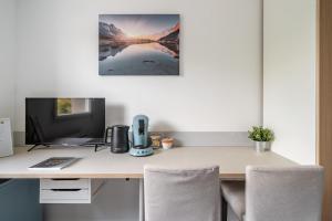 a desk with a computer and a monitor on it at Studio Tranquille et COSY Fonderie in Mulhouse