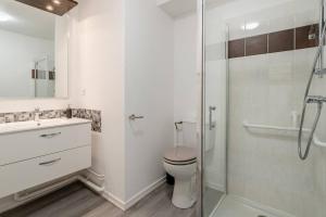 a bathroom with a toilet and a glass shower at Studio Tranquille et COSY Fonderie in Mulhouse