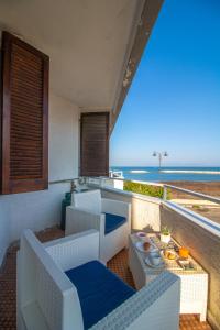 a balcony with a table and chairs and the ocean at 100 passi dal mare in Agropoli