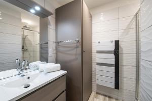 a bathroom with a sink and a shower at LES CHARMETTES in Brides-les-Bains +11 photos