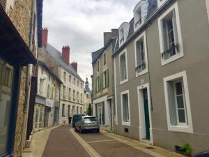 a car parked on a street with buildings at ChezLola in Civray