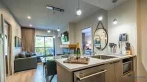 a kitchen with a sink and a living room at Château Morritt in Mont-Tremblant