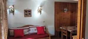 a bedroom with a bed with red and white pillows at Residence la Dame Blanche in Puy-Saint-Vincent