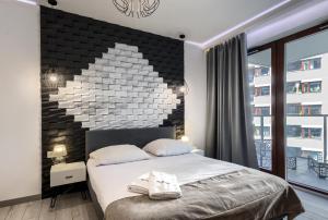 Łóżko lub łóżka w pokoju w obiekcie Kazou Residence Arkadia