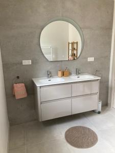 a bathroom with a white sink and a mirror at Les Bulles Blanches in Avize +59 photos