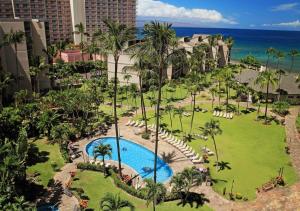 an aerial view of a resort with a pool and palm trees at Kaanapali Shores Condominiums by TS in Lahaina