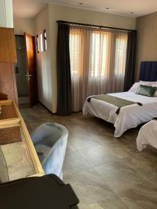 ein Hotelzimmer mit 2 Betten und einer Badewanne in der Unterkunft Hotel Arista 1026 in San Luis Potosí