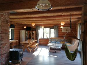 a living room with a couch and a hammock at Palmas in Jūrkalne