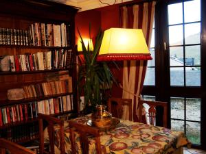 a dining room with a table with chairs and a lamp at Hotel Almud in Sallent de Gállego