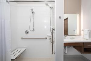 a bathroom with a shower and a sink at Staybridge Suites Rapid City - Rushmore, an IHG Hotel in Rapid City