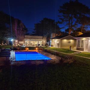 a house with a swimming pool at night at The GaTe beach house in Chapadmalal