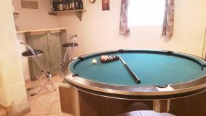 a pool table with a ball in a room at Ma baraque de vacances in Butgenbach