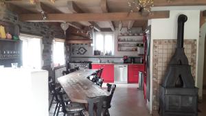 a kitchen with a wooden table and a stove at Ma baraque de vacances in Butgenbach