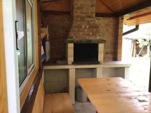 a porch with a table and a brick fireplace at Квартира in Yaremche