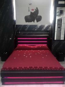 a bed with a red bedspread on top of it at Camera relax Fuorigrotta in Naples