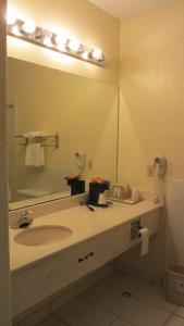 a bathroom with a sink and a large mirror at Americas Best Value Inn and Suites Houston FM 1960 in Houston