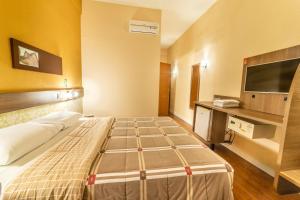 Postel nebo postele na pokoji v ubytování Hotel 10 Blumenau