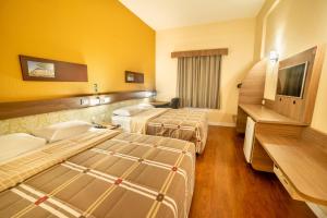Postel nebo postele na pokoji v ubytování Hotel 10 Blumenau