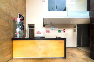 a lobby with a reception desk in a building at Hotel Kapu, Puebla in Puebla