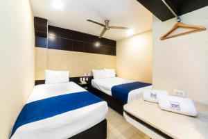 En eller flere senger på et rom på Hotel Kapu