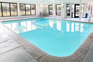 a large pool with blue water in a building at Staybridge Suites Reno Nevada by IHG in Reno